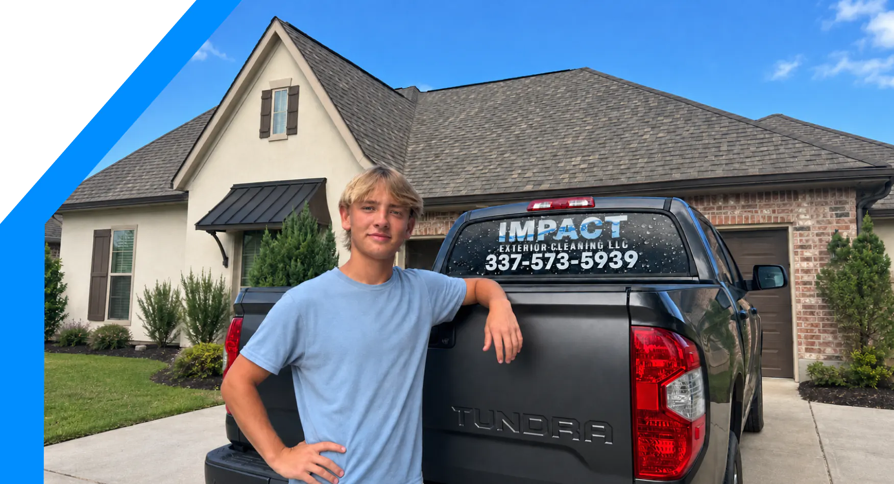 Evan Lyons with the Impact Exterior Cleaning truck outside a home in Acadiana